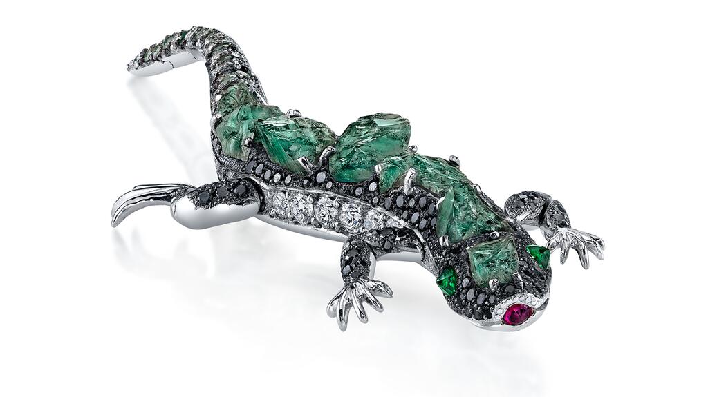 The 18-karat white gold “Alexis” brooch by Omi Privé, set with natural color-change rough alexandrite and diamonds with green tsavorite eyes, a ruby tongue, and a movable tail and legs. Omi Privé alexandrite lizard brooch